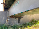 damaged leaking fiberglass overflow spillway before repair